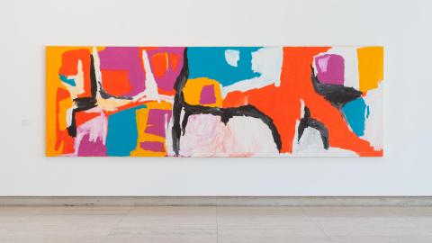 An installation view of a bright abstract artwork.