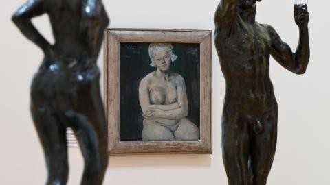 An installation view in which we see a nude by Picasso in between two bronze figures.