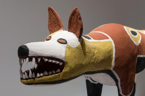 An installation view of a wood sculpture of a dog / Camp dog (Ku)