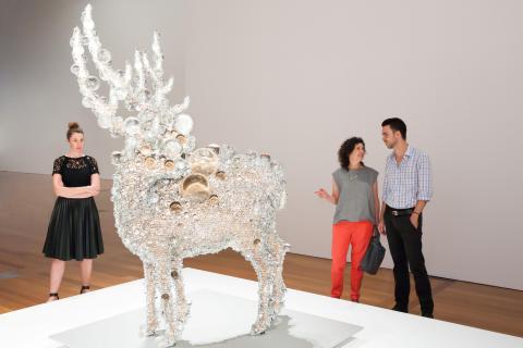 An installation view of a sculpture taking the form of a deer made of glass balls and beads.