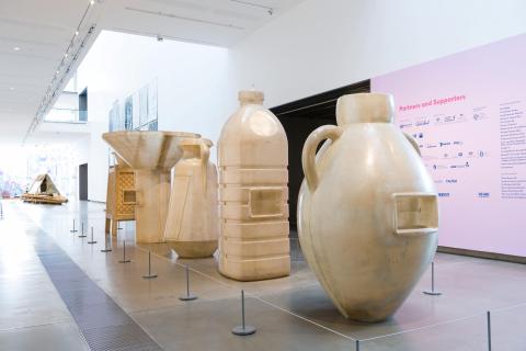 A photograph of five very large fibreglass water vessels installed on Level One at GOMA.