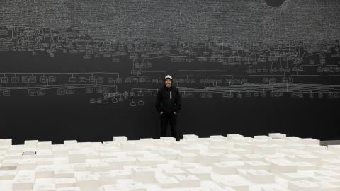 An artist stands with his room-scale installation work at the Australia Pavillion of the Venice Biennale