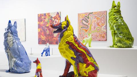 An installation of sculptures depicting brightly coloured dogs