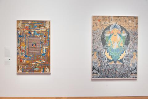 Two Mongol Zurag paintings installed on a white wall in a bright gallery space