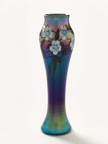 Artwork Baluster vase this artwork made of Blue iridescent glass body in baluster shape, with white padded and carved flowers, engraved trails and stained leaves, created in 1892-01-01