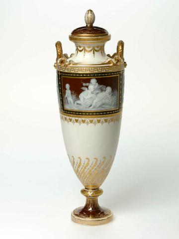 Artwork Covered vase this artwork made of Parian porcelain slip-cast urn shaped vase finely decorated in the pâte sur pâte technique with group of cupids against a rectangular brown ground with subsidiary pate sur pate scroll decoration against blue and brown grounds. Richly gilded, created in 1900-01-01