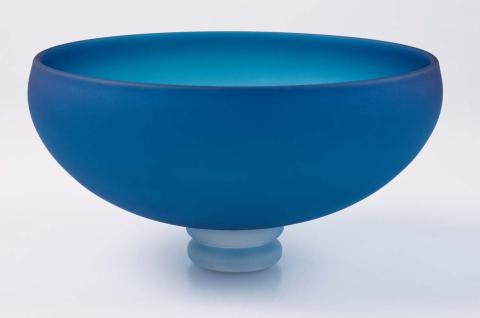 Artwork Frosted blue bowl this artwork made of Hot-worked cobalt blue glass of flattened ellipsoid shape and set on two clear glass circles.  Acid-dipped, created in 1983-01-01