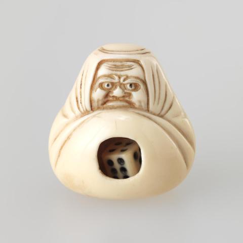 Artwork Netsuke:  (Daruma with dice) this artwork made of Carved ivory containing ivory dice, created in 1800-01-01