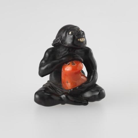 Artwork Netsuke:  (islander) this artwork made of Carved ebony with coral and bone or ivory, created in 1800-01-01