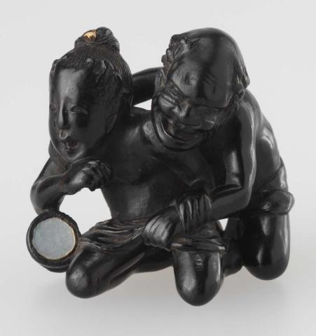 Artwork Netsuke:  (Rakan wrestling with a demon) this artwork made of Carved ebony with pearl shell, created in 1800-01-01
