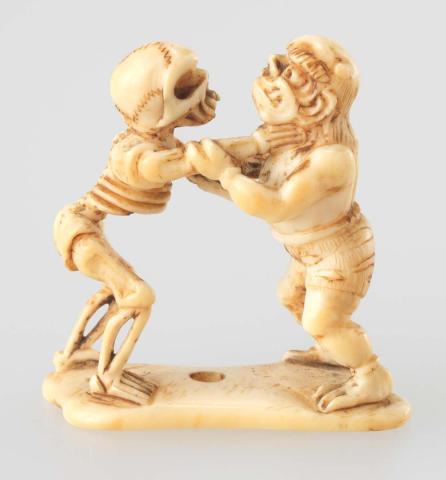 Artwork Netsuke:  (skeleton wrestling with a demon) this artwork made of Carved ivory on flat base, created in 1800-01-01