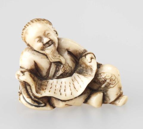 Artwork Netsuke:  (reclining Chinese poet) this artwork made of Carved ivory, created in 1800-01-01
