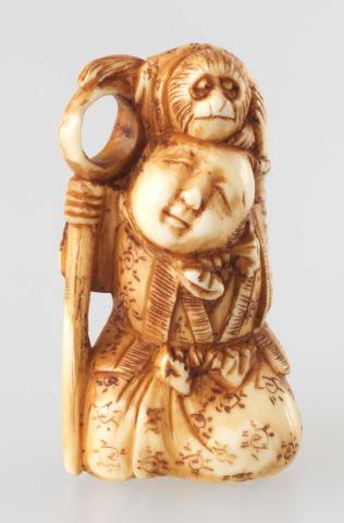 Artwork Netsuke:  (travelling showman with monkey) this artwork made of Carved ivory, created in 1800-01-01