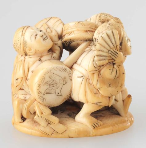 Artwork Netsuke:  (two drummers and a dancer) this artwork made of Carved ivory with flat base, created in 1800-01-01
