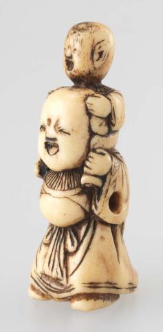 Artwork Netsuke:  (woman carrying a child) this artwork made of Carved ivory (or stag-horn?), created in 1800-01-01