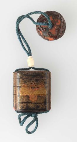 Artwork Inro with netsuke:  (leaf motif) this artwork made of Wood in four compartments with black lacquer and gold leaf.  Blue cord with ivory toggle and lacquer disc, created in 1800-01-01