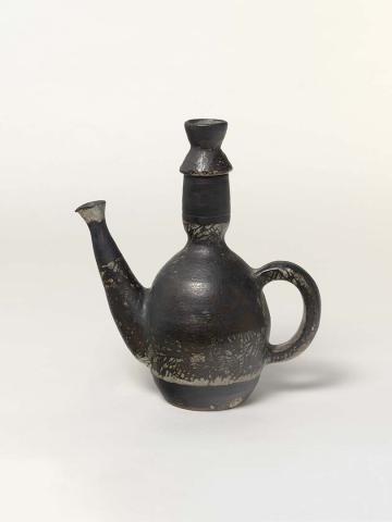 Artwork Teapot this artwork made of Globular white earthenware body with narrow neck and waisted lid, protruding spout with flared lip.  Light green speckled glaze with heavy manganese brushwork, created in 1950-01-01
