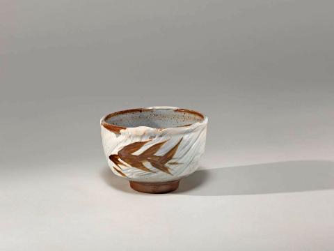 Artwork Tea bowl this artwork made of Stoneware, thrown red bodied clay with greyish Hakame brushwork and iron brush decoration, created in 1975-01-01