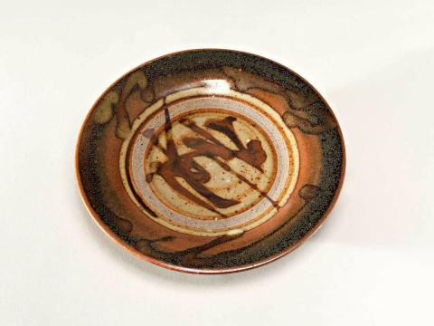 Artwork Small plate this artwork made of Stoneware, thrown with glaze free firing rim and brown and greenish glaze. (Production ware), created in 1978-01-01