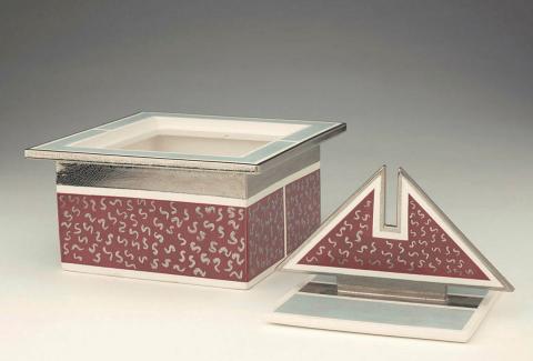 Artwork Box with platinum lustres this artwork made of Square slab built porcelain box with projecting lip and shaped handle. Blue and light maroon glazes with platinum lustres, created in 1987-01-01