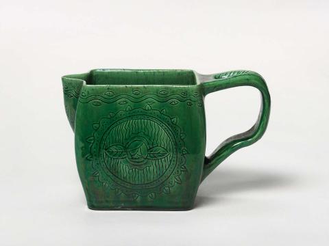 Artwork Jug this artwork made of Hand and slab built white earthenware body of rectangular section with strap handle and thumb indentation.  Incised with Omega Studio style floral motif and green glaze, created in 1922-01-01