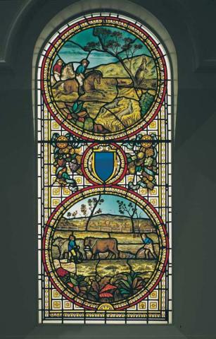 Artwork Sidney House stained glass window this artwork made of Coloured and stained glass window in two panels - the upper (arched) panel depicting a kangaroo hunt and the lower a farming scene