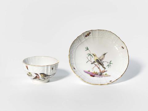 Artwork Cup and saucer this artwork made of Hard-paste porcelain with irregular rim and relief basket weave design.  Finely painted in polychrome overglaze colours with birds on branches and insects. Moth in well of cup