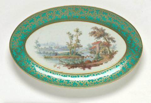 Artwork Oval dish this artwork made of Soft-paste porcelain with a wide apple green border of gilt vermicule and a roughly applied gilt border enclosing an extensive river landscape with a man fishing and watermill in polychrome enamels, created in 1785-01-01