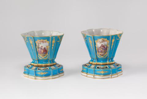 Artwork Pair of vases Hollandaises this artwork made of Hard-paste porcelain shaped flared oval vases on pierced shaped base, the bleu celeste ground reserved and painted with lovers in a garden landscape and foliate bunches with gilt details.  Gilded insets