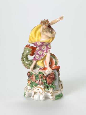 Artwork Figurine of Neptune this artwork made of Soft-paste porcelain figure of Neptune standing in a yellow-lined floral cloak, the mound base moulded with a polychromed dolphin, shells and seaweed surmounting polychromed gilt edged rococo scrolls, created in 1765-01-01