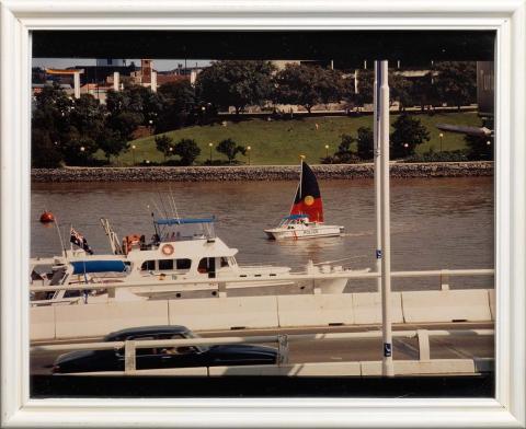 Artwork Boat with Aboriginal flag sailing on Brisbane River (from 'Portraits' series) this artwork made of Type C photograph