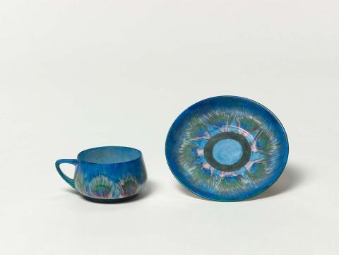 Artwork Cup and saucer:  Peacock feather motif this artwork made of Hard-paste porcelain blank with overglaze colours, created in 1915-01-01