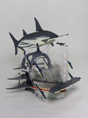 Artwork Beizam headdress (Shark with bait fish) this artwork made of Plywood, enamel paint, wire, feathers, shark's teeth, string, created in 1995-01-01