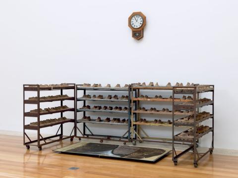 Artwork Image of absence this artwork made of Book comprising 13 leaves with 11 dry pigment and wax drawings;  clock;  wood and steel shoe-last racks;  and wooden shoe-lasts