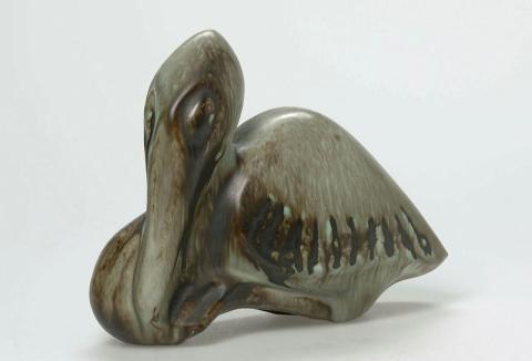Artwork Pelican sitting this artwork made of Earthenware, slip-cast terracotta clay with running dark brown and green glaze, created in 1953-01-01