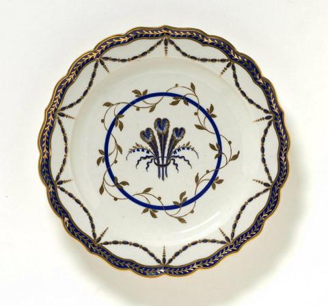 Artwork Pair of plates:  (Prince of Wales' feathers) this artwork made of Soft-paste porcelain, press-moulded with cobalt underglaze details and gilt, created in 1783-01-01