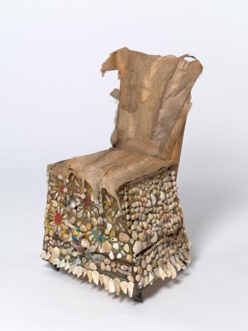 Artwork Chair:  Tra Strand, Townsville this artwork made of Found timber and hinges applied with shells, pigment and palm fibre stitched with cotton, created in 1998-01-01