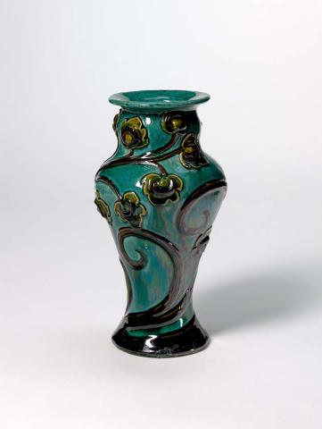 Artwork Vase: (art nouveau) this artwork made of Earthenware, handbuilt with foliate motif applied with brown slip and blue-green glaze