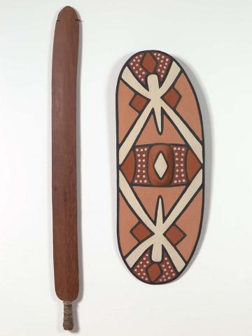 Artwork Rainforest shield (pond skater design) and sword this artwork made of Shield:  natural pigments on softwood (Alstonia scholaris or Argyrodendron perlatum);  sword:  hardwood (Xanthostemon whitei), beeswax and resin with bush string