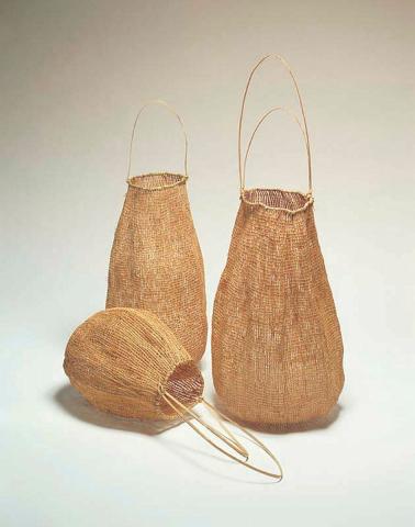 Artwork Kakan (Baskets) this artwork made of Baskets: Twined black palm (Normanbya normanbyi) fibre; handles: lawyer cane (Calamus sp.) fibre, created in 2002-01-01
