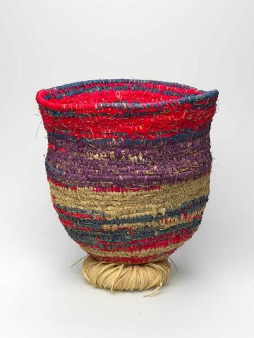 Artwork Basket with manguri (circular hair ring) this artwork made of Coil-woven desert grass (tjanpi), with synthetic raffia and dyed and natural raffia; desert grass (tjanpi) bound with natural raffia, created in 2004-01-01