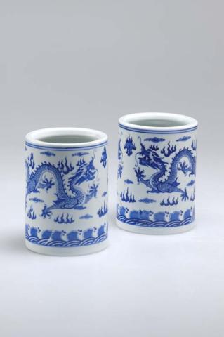 Artwork Pair of brush pots this artwork made of White porcelain with cobalt oxide underglaze design of pair of dragons, flaming pearl and clouds, created in 1920-01-01