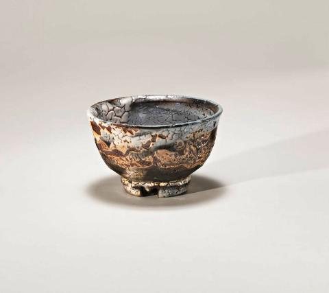 Artwork Tea bowl with cut foot this artwork made of Stoneware, wheelthrown clay modified with granulated feldspar with wax resist, iron and cobalt slips and crawled Shino and salt glazes