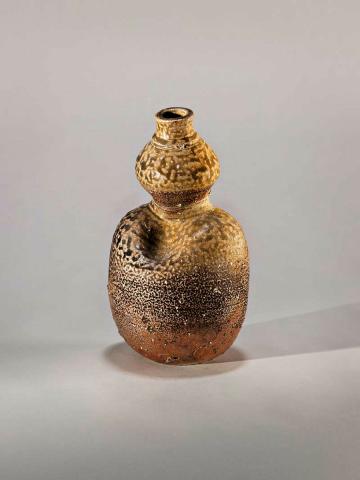 Artwork Bottle, woman form this artwork made of Stoneware, wheelthrown with granulated feldspar, stone explosions, distorted and wood ash and salt glazes
