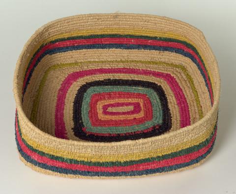 Artwork Tjanpi (Grass basket) this artwork made of Coil-woven grass with commercially dyed natural and synthetic raffia