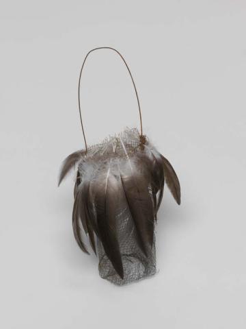 Artwork Narrbong (String bag) this artwork made of Rusted gauze wire with black pelican down