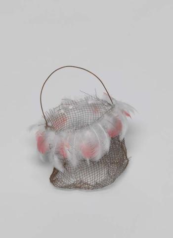 Artwork Narrbong (String bag) this artwork made of Rusted gauze wire with galah feathers and pelican down