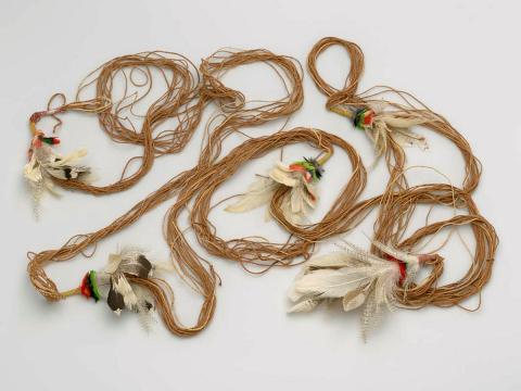 Artwork Banumbirr (Morning Star string) this artwork made of Bark fibre string with feathers, created in 2000-01-01
