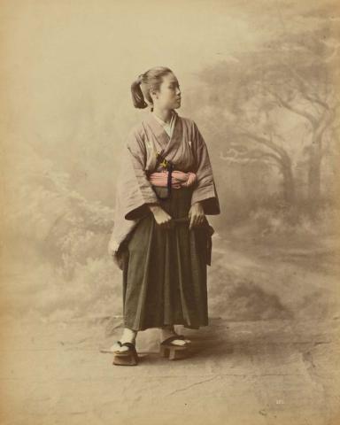 Artwork (Young lady wearing hakama kimono) (from 'Japan' album) this artwork made of Hand-coloured albumen photograph on board (originally bound in an album), created in 1870-01-01
