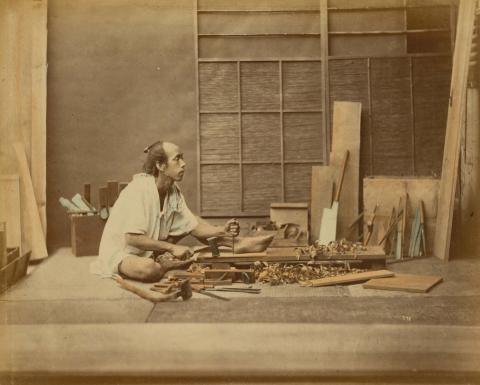 Artwork (Carpenter) (from 'Japan' album) this artwork made of Hand-coloured albumen photograph on board (originally bound in an album), created in 1870-01-01